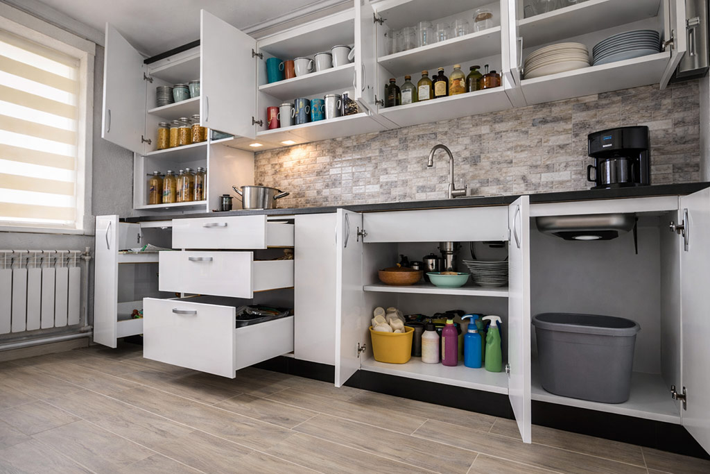 renovated interior modern trendy white kitchen with doors open